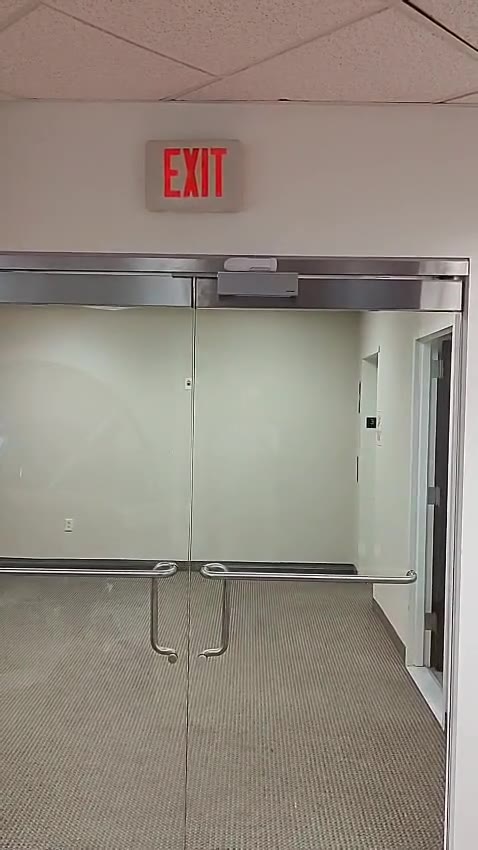 Glass double doors with overhead lock hardware from our work on Long Island